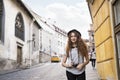 Beautiful young tourist with camera in the old town. Royalty Free Stock Photo