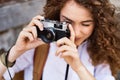 Beautiful young tourist with camera in the old town. Royalty Free Stock Photo