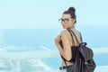 Beautiful young tourist girl with backpack near sea Royalty Free Stock Photo