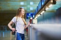 Beautiful young tourist girl in international airport at check-in counter Royalty Free Stock Photo