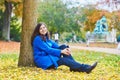 Beautiful young tourist in Paris on a fall day Royalty Free Stock Photo