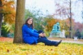 Beautiful young tourist in Paris on a fall day Royalty Free Stock Photo