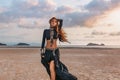 Beautiful young tribal style woman on the beach at sunset