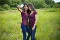 Beautiful young twins girls doing selfie