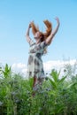 Beautiful young vital woman enjoying in nature in the fresh air. Joy. Freedom. Happiness. Lust raises her arms Royalty Free Stock Photo