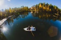 Beautiful young wedding couple on small boat sailing on a pond Royalty Free Stock Photo