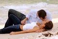 Beautiful young wet couple kissing on beach Royalty Free Stock Photo