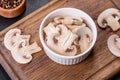 Beautiful young white champignons torn to slices on a dark concrete background Royalty Free Stock Photo