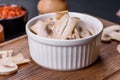 Beautiful young white champignons torn to slices on a dark concrete background Royalty Free Stock Photo