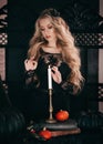 Beautiful young witch girl. Halloween girl in black