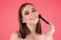 Beautiful young woman apply powder on face. Beauty Makeup. Portrait of female model with cosmetic brush. Perfect soft Royalty Free Stock Photo