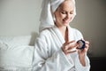 Beautiful young woman applying body lotion after a shower Royalty Free Stock Photo