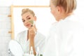 Beautiful young woman applying facial mask with aloe vera extract at home Royalty Free Stock Photo