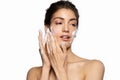 Beautiful young woman applying foam cleanser. Royalty Free Stock Photo