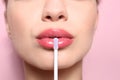 Beautiful young woman applying gloss on her perfect lips Royalty Free Stock Photo