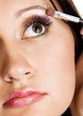 Beautiful young woman applying makeup Royalty Free Stock Photo