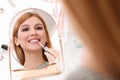 Beautiful young woman applying makeup near mirror Royalty Free Stock Photo