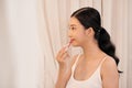 Beautiful young woman applying makeup near mirror in dressing room Royalty Free Stock Photo