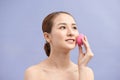 Beautiful young woman applying makeup using beauty blender sponge Royalty Free Stock Photo