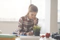 Beautiful young woman architect is keeping notes in her office Royalty Free Stock Photo