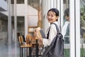 Beautiful young woman asian with backpack and book. College student carrying lots of books in college campus Royalty Free Stock Photo