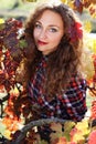 Beautiful young woman in autumn grape vineyard