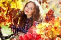 Beautiful young woman in autumn grape vineyard