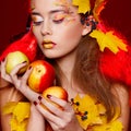 Beautiful young woman with autumn make up holding apples in her Royalty Free Stock Photo