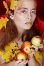 Beautiful young woman with autumn make up holding apples in her Royalty Free Stock Photo