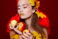 Beautiful young woman with autumn make up holding apples in her Royalty Free Stock Photo