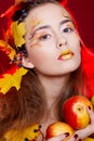 Beautiful young woman with autumn make up holding apples in her Royalty Free Stock Photo