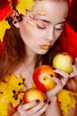 Beautiful young woman with autumn make up holding apples in her Royalty Free Stock Photo