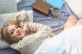 Beautiful young woman awaking and smiling at home, top view.