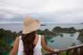 beautiful young woman back in front of typical west papua landscape