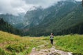 Beautiful young woman with backpack hiking in beautiful Rysy mountains, Tatra, Poland, Slovakia