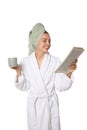 Beautiful young woman in bathrobe reading newspaper on background Royalty Free Stock Photo