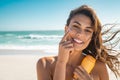 Smiling woman applying sunscreen Royalty Free Stock Photo