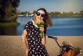 Beautiful young woman on the beach with bicycle and flowers Royalty Free Stock Photo