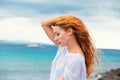 Beautiful young woman on the beach, enjoying nature watching the sunset Royalty Free Stock Photo