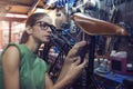 A beautiful young woman bicycle mechanic is repairing a bike in the workshop Royalty Free Stock Photo