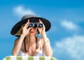 Beautiful young woman in bikini looking through binoculars Royalty Free Stock Photo