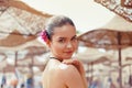 Beautiful young woman in bikini smear protective cream on the skin on the beach under the sun. Royalty Free Stock Photo
