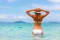 Beautiful young woman in bikini on the sunny tropical beach