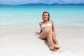 Beautiful young woman in bikini on the sunny tropical beach relaxing Royalty Free Stock Photo