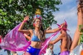 Beautiful young woman in bikini walking on stilts during Bloco Orquestra Voadora in support of feminism at Carnaval 2017