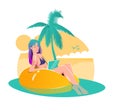 beautiful young woman in a bikini works at a laptop, sitting in a yellow rubber ring on pool or sea. Freelance concept Royalty Free Stock Photo