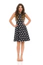 Beautiful Young Woman In Black Cocktail Dress In Polka Dots And Beige High Heels Sandals Royalty Free Stock Photo