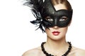 Beautiful young woman in black mysterious venetian mask Royalty Free Stock Photo