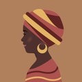 Beautiful young woman with black skin. African girl in traditional headdress. Smiles, scarf is wound on her head, earring in her