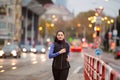 Beautiful young woman in black vest running in the city